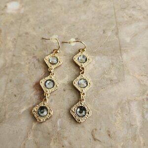 Stony Dangle Style Earrings with Silver-Colored Stone in Gold Setting